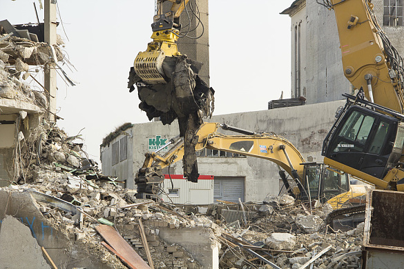 Excavators knock down buildings